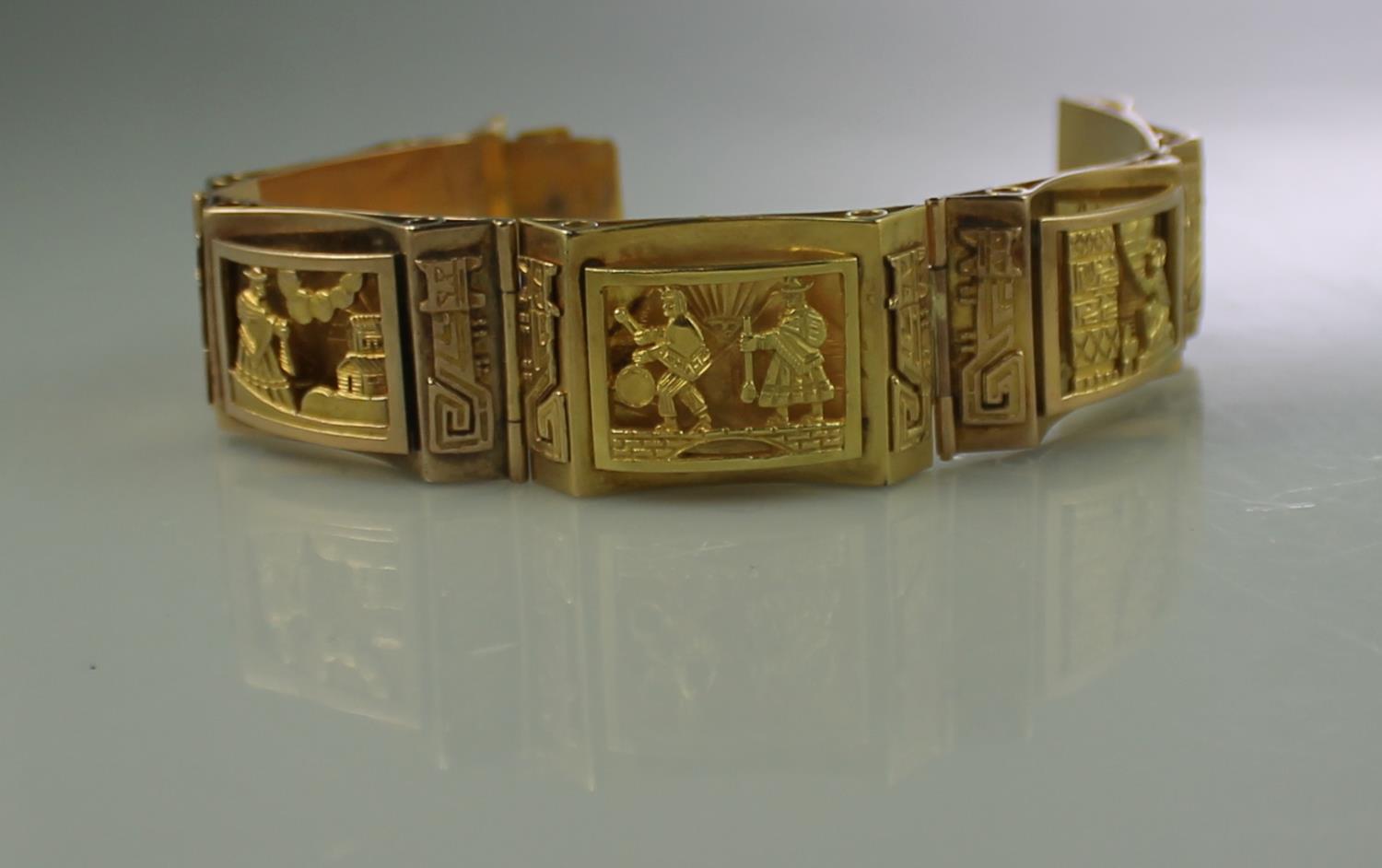 18CT GOLD WIDE HEAVY BRACELET of rectangular links with engraved scenes. Having clasp and safety
