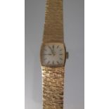 9CT GOLD LADIES OMEGA WRISTWATCH. Square face with black hands and baton numerals. Integral gold