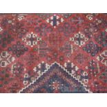 PERSIAN JOSHAGHAN WOOL CARPET on a red ground, central lozenge surrounded by other stylised floral