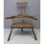 PRIMITIVE OAK, ASH AND ELM COMB BACKED STICK BACKED ELBOW CHAIR having solid seat on three legs.