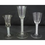 A GROUP OF THREE 18TH CENTURY GLASS PEDESTAL DRINKING GLASSES to include; tall hive shaped cordial