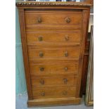 VICTORIAN PALE OAK WELLINGTON CHEST having moulded top with carved decoration above a straight front