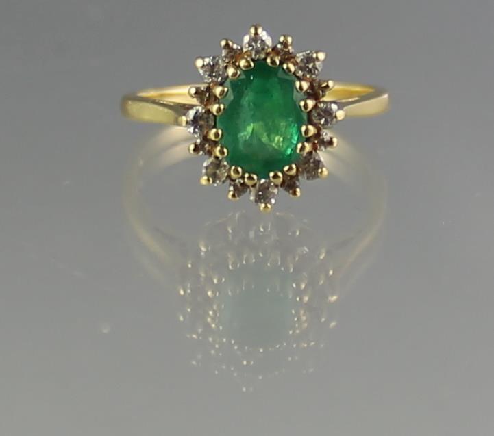 18CT GOLD EMERALD AND DIAMOND CLUSTER RING. The oval deep green claw set emerald (8 x 6mm approx) - Image 2 of 2