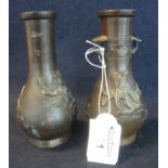 Pair of Meiji period Japanese small bronze baluster shaped two handled vases with relief decoration,