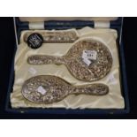 Cased silver backed three piece dressing table mirror and brush set. Fitted box. (B.P. 21% + VAT)