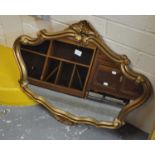 Modern gilt framed mirror of oval form with scroll decoration. (B.P. 21% + VAT)