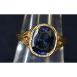 Yellow metal ring set with a large oval sapphire in closed back setting. Approximate weight 8 grams.