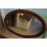 Oval wall mirror with inlaid oak frame and bevelled plate. (B.P. 21% + VAT)