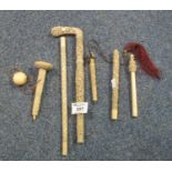 A group of assorted Chinese ivory parasol handles and similar items, all with overall carving. (