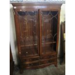 Reproduction mahogany two door glazed bookcase, having moulded dentil cornice and an arrangement