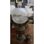 Brass double burner oil lamp with etched glass globe shade and clear chimney, together with a