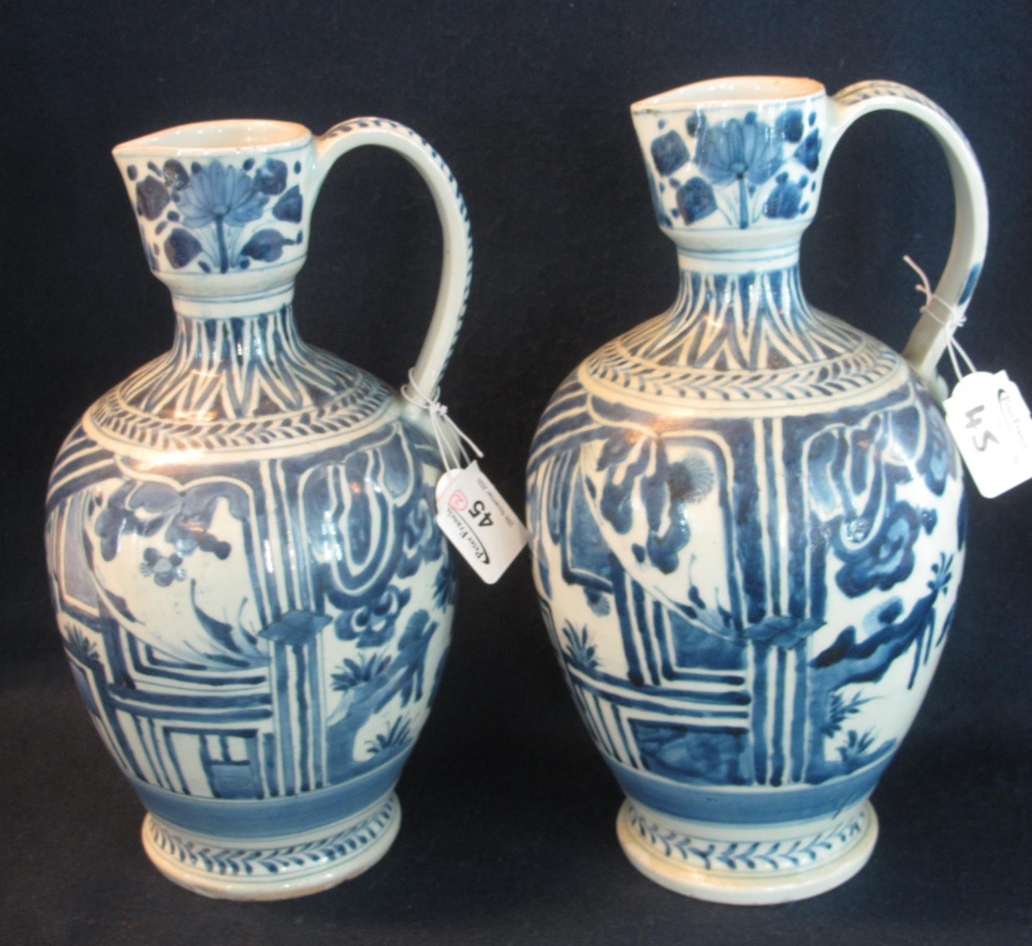 Two similar Japanese Arita porcelain baluster shaped wine jugs with loop handles, overall