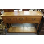 Reproduction oak dresser base having moulded top above three drawers. (B.P. 21% + VAT)