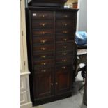 Early 20th Century stained oak straight front filing cabinet having a bank of 16 drawers above two