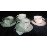 Set of four Belleek Irish porcelain conical conch shell shaped cabinet cups and saucers with black