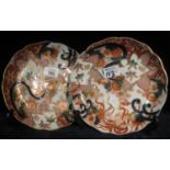 Pair of Japanese porcelain Imari design wave edged shallow dishes, overall with floral and