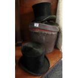 Traditional leather oval section hat box with dished lid, together with two silk top hats. (B.P. 21%