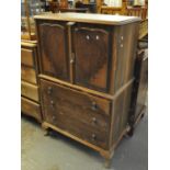 Mid Century walnut blind panelled cabinet above three fitted drawers standing on cabriole legs. (B.