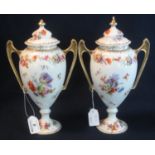 Pair of German porcelain floral transfer printed two handled urn shaped vases and covers, crowned