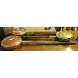Two copper warming pans and one brass warming pan, all with turned handles. (3) (B.P. 21% + VAT)