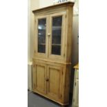 Victorian stripped pine two stage corner cabinet having shaped shelves to the interior. (B.P.