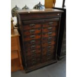 Edwardian mahogany and walnut tambour and straight front filing cabinet having a bank of 18