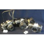 Three Olympus 35mm SLR OM10 camera bodies with two Olympus 50mm lenses , two with everready