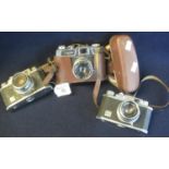 Three Halina 35mm viewfinder cameras to include 35X (2) and Halina super 35X in everready case. (