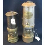 Two brass miner's safety lamps, including a smaller one in used condition and an E Thomas & Williams