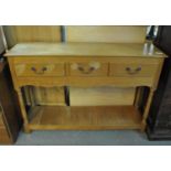 Reproduction oak dresser base having moulded top above three drawers. (B.P. 21% + VAT)