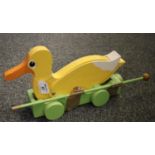 A painted hardwood pull along toy duck on wheels with moving motion, made by John C Davies of Hakin,
