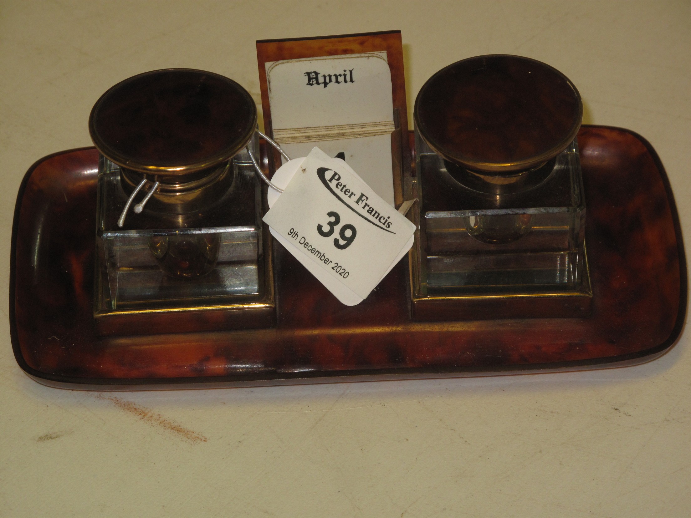 A simulated tortoiseshell brass mounted double inkwell desk stand with central calendar and - Image 2 of 4