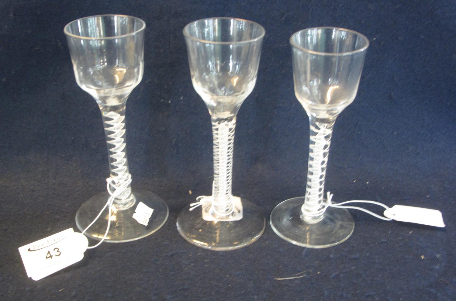 Three similar Georgian opaque multiple twist stem ale glasses with circular feet, two with