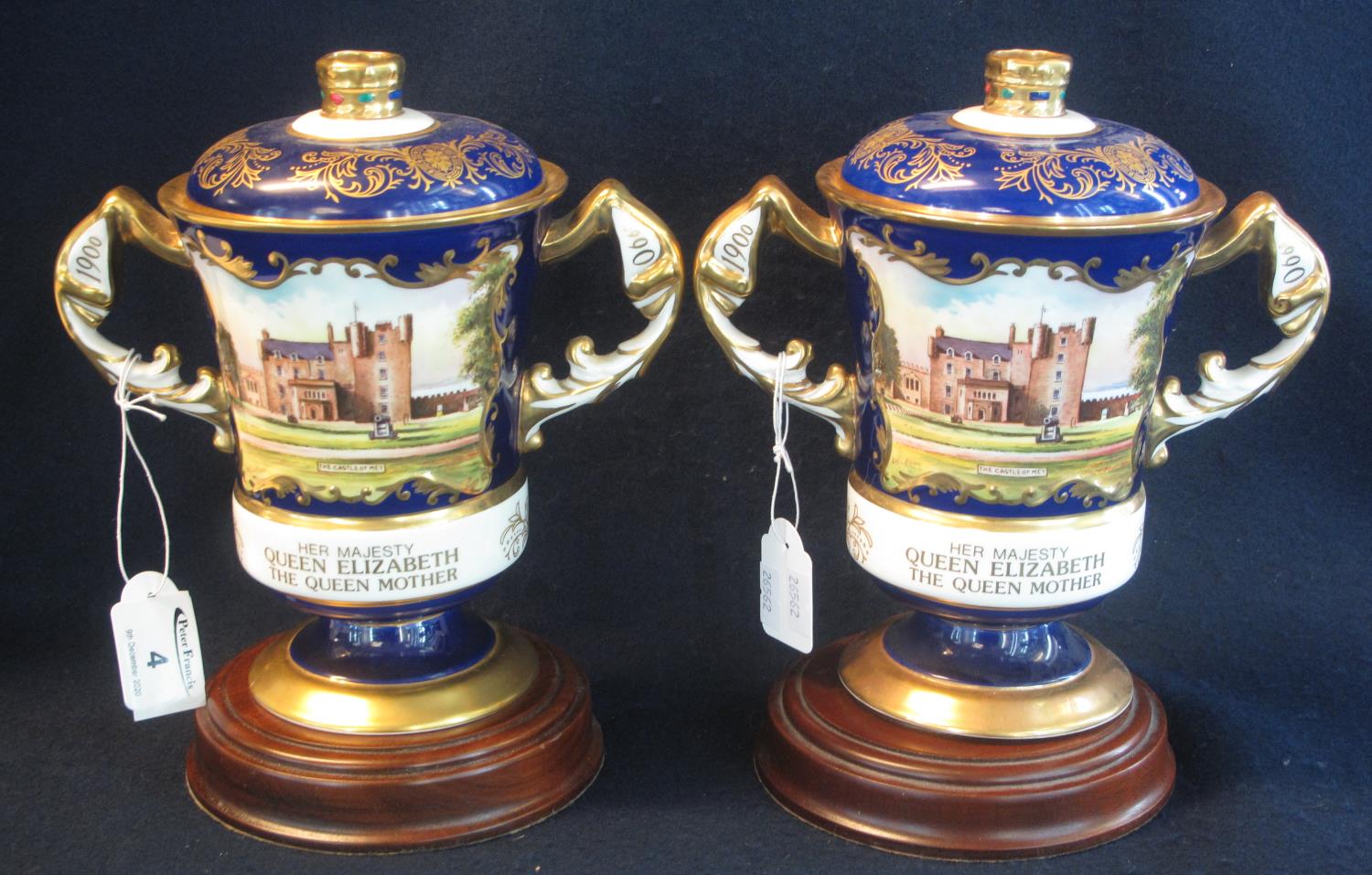 Two Aynsley bone china hand painted lidded two handled commemorative vases for Her Majesty Queen