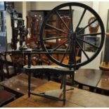 A modern stained treadle spinning wheel. (B.P. 21% + VAT)