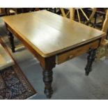 Late Victorian oak farmhouse table having two pull out drawers, standing on carved baluster legs. (