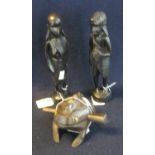 Two small African carved ebony figures, male and female, together with a carved wooden toad with