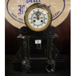 A 19th Century black slate and marble drum head two train mantel clock having Roman enamel face with