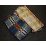 Box containing two vintage blankets, one woollen check fringed blanket and another multi-colour