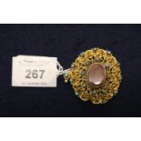 A yellow metal filigree brooch set with turquoise, ruby and goldstone. Approximate weight 13.4