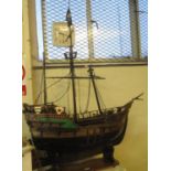 Rustically made scale model of a pirate galleon, three masted on wooden stand. 112cm long approx.