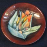 Modern Moorcroft art pottery dish with tube lined floral decoration. Impressed marks to base with