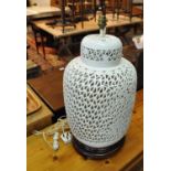 Oriental design cream pierced baluster table lamp on wooden base. (B.P. 21% + VAT)