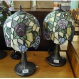A pair of modern Tiffany style table lamps, the shades decorated with stylised roses. (2) (B.P.