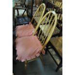A pair of elm and beech Ercol spindle and hoop back kitchen chairs. (2) (B.P. 21% + VAT)