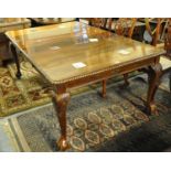Early 20th century mahogany extending dining table with rope twist edge above carved foliate and