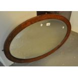 Oval wall mirror with inlaid oak frame and bevelled plate. (B.P. 21% + VAT) Minor wear with age.