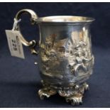 19th Century silver repousse baluster shaped mug with C scroll handle and pierced scrollwork feet,