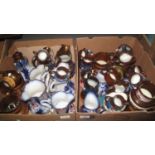 Two trays of Victorian and other copper lustre and similar dresser jugs, varying sizes and forms. (