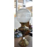 Early 20th century double oil burner lamp with globular etched shade on a brass reservoir and